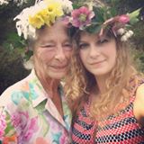Grandmother and Granddaughter wearing Spring flowers in their hair; gardening