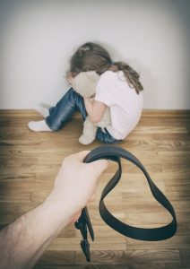 Little girl crying in the corner. Domestic violence concept.