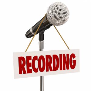 microphone with sign saying "RECORDING"