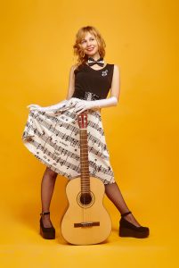 Girl holding up a skirt made of musical notes and holding a guitar by Victoria_Borodinova for Solfeggio frequencies